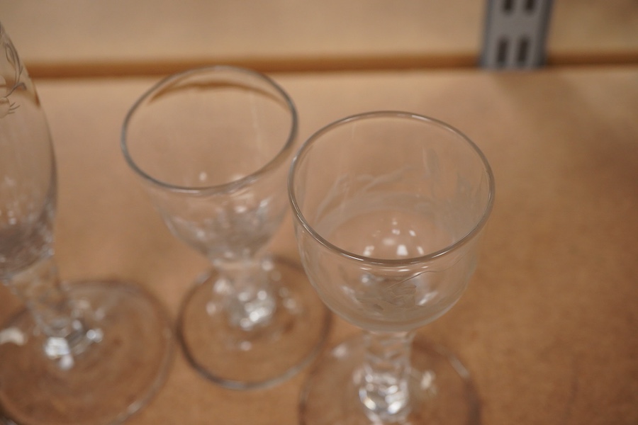 Four Georgian wine glasses, three with engraved bowls, three with faceted stems, and one with an air twist knopped stem and stepped foot, tallest 16cm